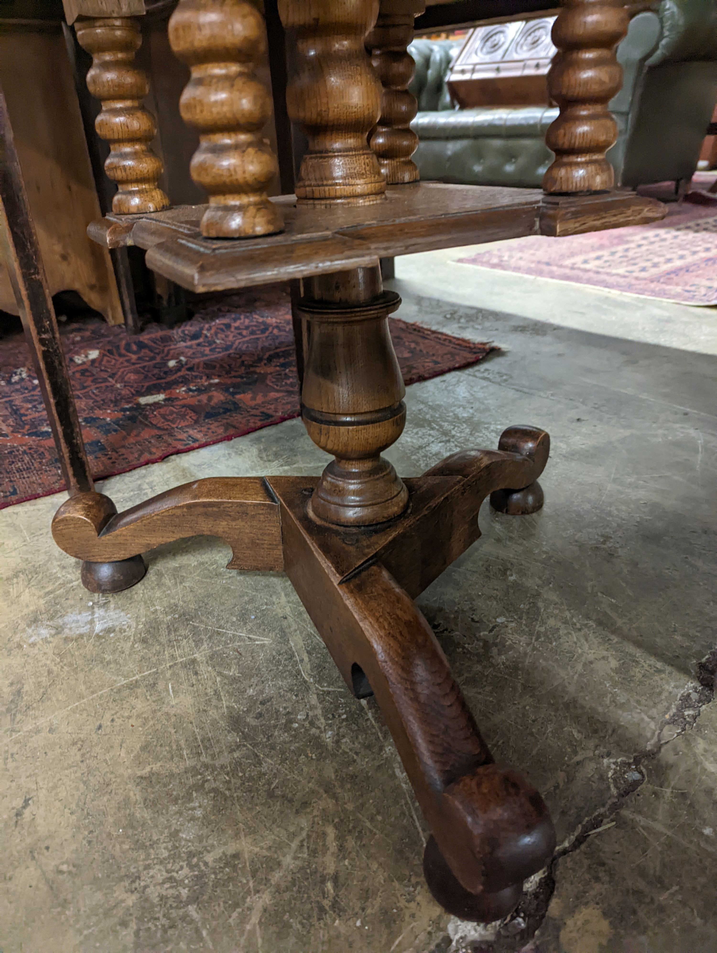 An early 20th century circular oak tripod book table, diameter 60cm, height 69cm